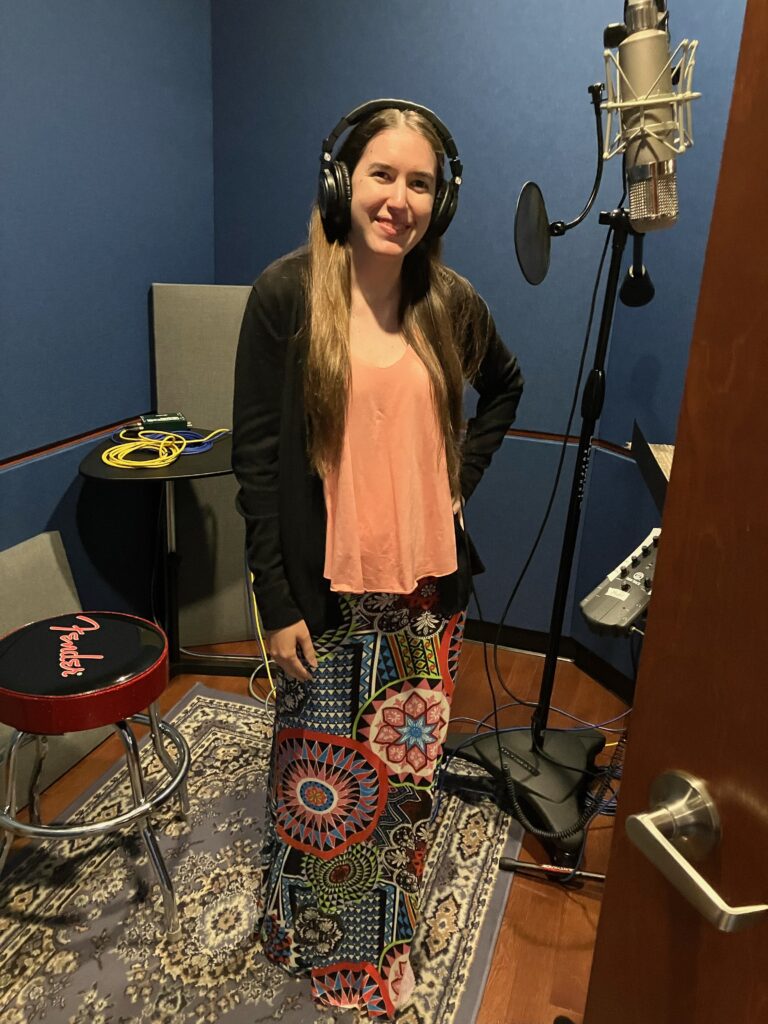 Demi Michelle smiling in the booth at the session