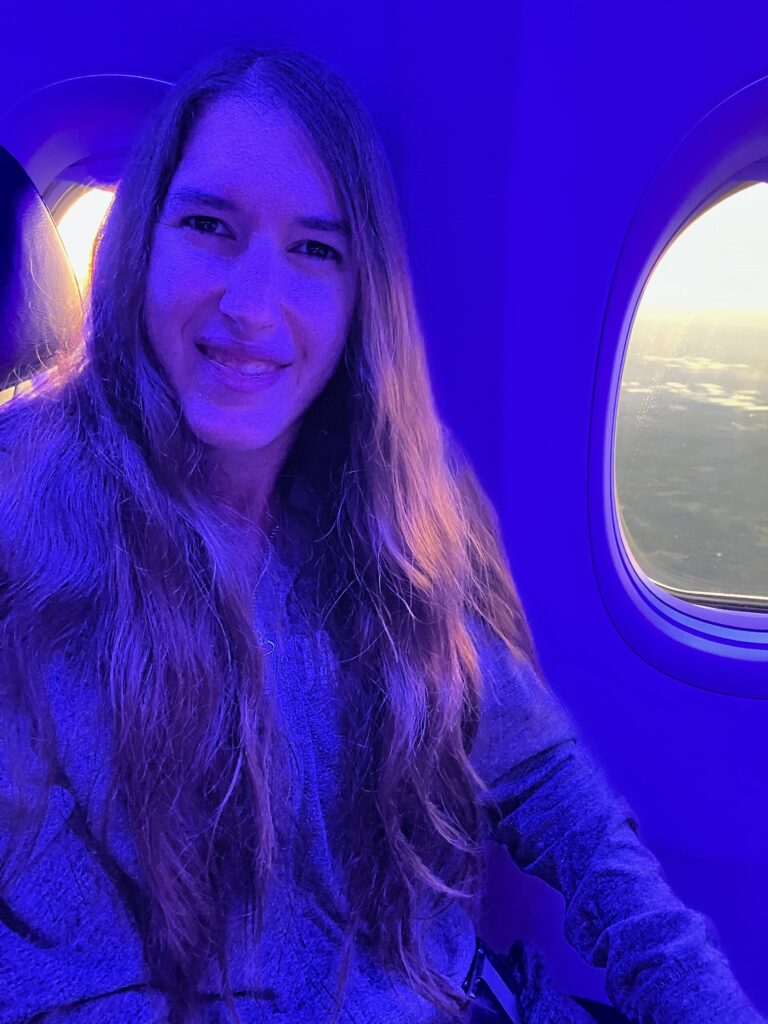 Demi smiling on the plane to Nashville