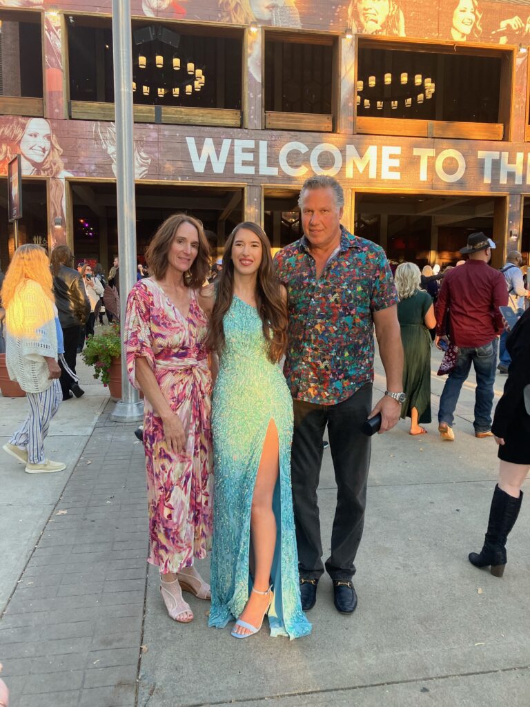 Demi and her parents outside at the Opry