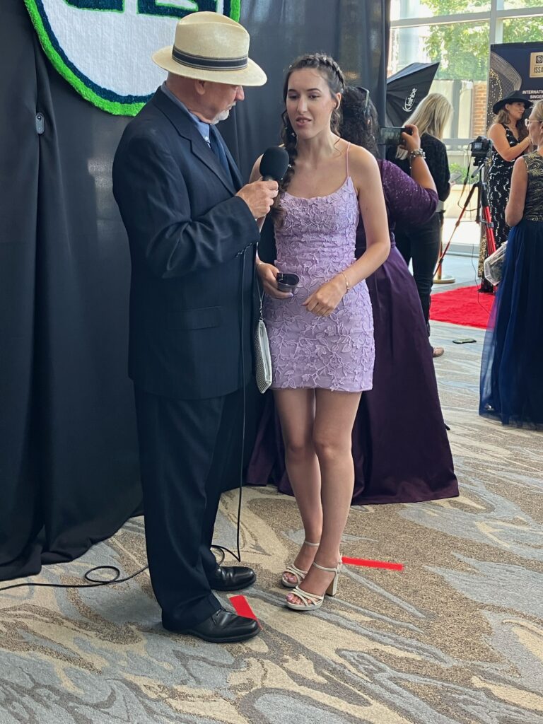 Demi Michelle doing an interview on the red carpet