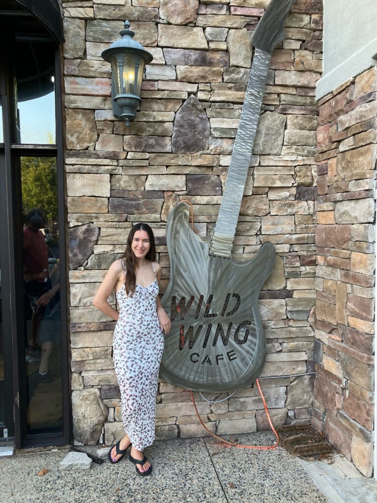 Demi Michelle at Wild Wing Cafe for the pre-party and wearing a butterfly dress