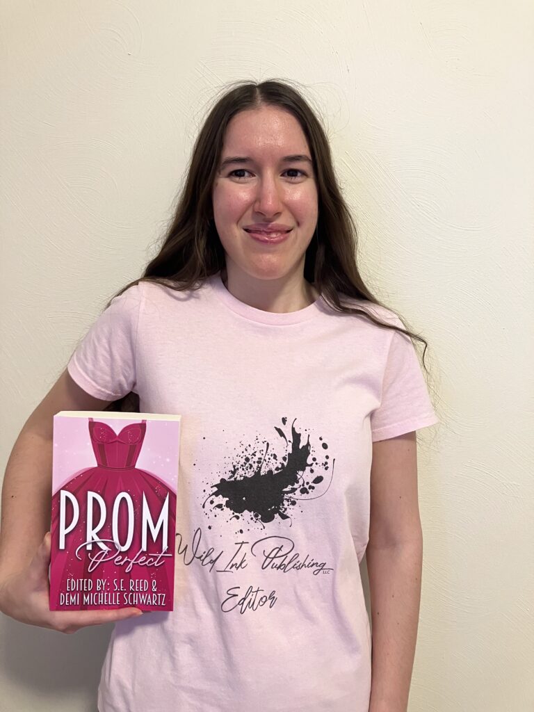 Demi smiling with her copy of Prom Perfect
