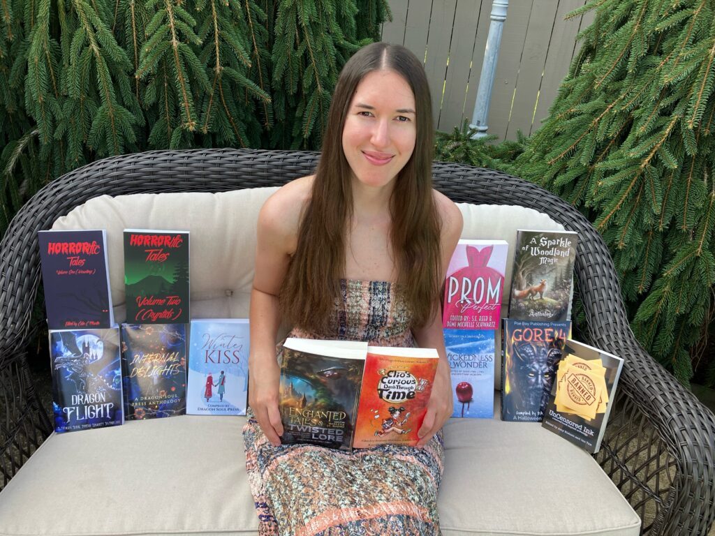 Demi wearing a maxi dress and sitting on a wicker chair with all her anthologies