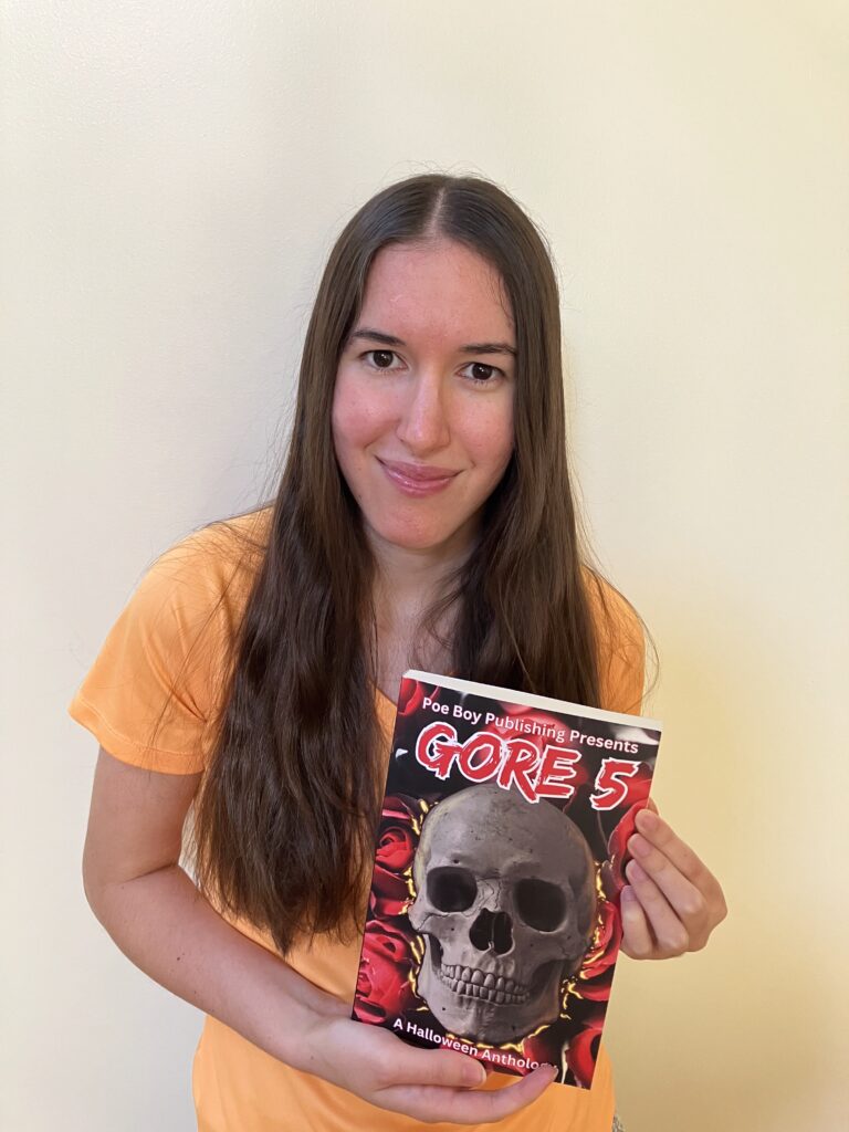 Demi smiling with her copy of GORE 5: Curses