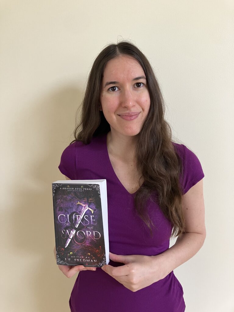 Demi smiling with her copy of Curse of the Sword